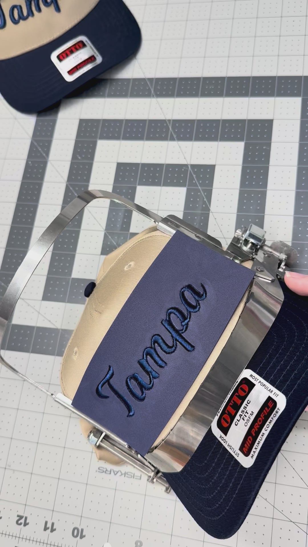 Pulling off the puff sheet on a newly embroidered Tampa hat
